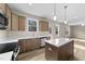 Bright kitchen with island, stainless steel appliances, wood cabinets, and hardwood floors at 9133 Phoenix Ct, Middlesex, NC 27557