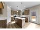 Bright kitchen with island, stainless steel appliances, wood cabinets, and hardwood floor at 9133 Phoenix Ct, Middlesex, NC 27557