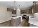 Modern kitchen with stainless steel appliances, an island, and wooden cabinets at 9133 Phoenix Ct, Middlesex, NC 27557
