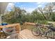 Backyard deck with 2 bicycles, outdoor furniture and view of trees at 1320 S State Street # D, Raleigh, NC 27610