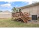 View of wooden deck featuring stairs leading down to lawn at 1320 S State Street # D, Raleigh, NC 27610
