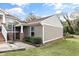 Charming townhouse exterior with a brick and siding facade, complimented by lush green lawn and mature trees at 1320 S State Street # D, Raleigh, NC 27610