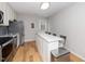 Clean kitchen with stainless steel appliances, an island with seating, and a door to the outside at 1320 S State Street # D, Raleigh, NC 27610