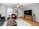 Cozy living room featuring hardwood floors, a large TV, and a comfortable chair at 1320 S State Street # D, Raleigh, NC 27610