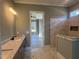Bathroom with a double vanity, marble floors, and a tiled shower with built-in niche at 142 Batten Hill Ln, Selma, NC 27576