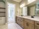 Bathroom with dual sink vanity, marble countertop, and walk-in closet at 142 Batten Hill Ln, Selma, NC 27576