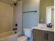 Stylish bathroom with tiled shower and tub combo, modern vanity, and neutral-toned walls at 142 Batten Hill Ln, Selma, NC 27576