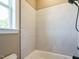 Bathroom featuring a tiled bathtub, white walls, and a shower head at 142 Batten Hill Ln, Selma, NC 27576