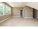 Spacious bedroom featuring large windows, neutral walls, and light wood-look floors at 142 Batten Hill Ln, Selma, NC 27576
