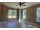 Spacious bedroom boasts natural light from multiple windows and features a ceiling fan at 142 Batten Hill Ln, Selma, NC 27576