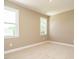 Cozy bedroom with neutral walls, carpeted floor, and two bright windows at 142 Batten Hill Ln, Selma, NC 27576