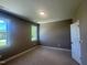 This bedroom features neutral walls and carpet, along with dual windows for ample natural light at 142 Batten Hill Ln, Selma, NC 27576