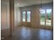 The bright foyer features decorative wainscoting, light wood floors, and elegant glass front doors at 142 Batten Hill Ln, Selma, NC 27576