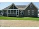 Back exterior view of a house with screened porch and spacious backyard at 142 Batten Hill Ln, Selma, NC 27576