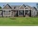 Charming home featuring stone accents, shingle siding, and a well-manicured lawn at 142 Batten Hill Ln, Selma, NC 27576