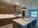 Well-lit kitchen featuring modern appliances, a kitchen island, and white subway tile at 142 Batten Hill Ln, Selma, NC 27576