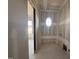 Functional laundry room space featuring a unique oval window, awaiting your custom design touches at 142 Batten Hill Ln, Selma, NC 27576