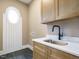 Laundry room showcasing a sink, countertop, and custom cabinetry at 142 Batten Hill Ln, Selma, NC 27576
