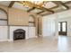 Open living room featuring a cozy fireplace, built-in shelving, and beautiful wood flooring at 142 Batten Hill Ln, Selma, NC 27576