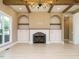 Living room boasting a brick fireplace, custom built-ins, and exposed wood beams at 142 Batten Hill Ln, Selma, NC 27576