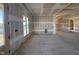 Open-concept living area with large windows, arched doorways, and unfinished walls awaiting finishing touches at 142 Batten Hill Ln, Selma, NC 27576
