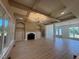 Spacious living room featuring a fireplace, elegant floors, and views to the entryway and kitchen at 142 Batten Hill Ln, Selma, NC 27576