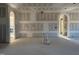 Open living area showcasing a large window and an arched doorway, in need of finishing at 142 Batten Hill Ln, Selma, NC 27576