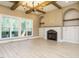 Spacious living room featuring a cozy fireplace, built-in shelving, and ample natural light at 142 Batten Hill Ln, Selma, NC 27576