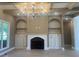 Inviting living room featuring a cozy fireplace, a tray ceiling, and decorative shelving at 142 Batten Hill Ln, Selma, NC 27576
