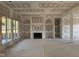 Unfinished living room boasting a fireplace, arched built-ins and large windows, offering great potential at 142 Batten Hill Ln, Selma, NC 27576