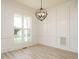 Bright living space featuring white trim, beautiful windows and luxury vinyl plank flooring at 142 Batten Hill Ln, Selma, NC 27576