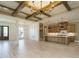 Open-concept kitchen and living space with wood beams and luxury vinyl plank flooring at 142 Batten Hill Ln, Selma, NC 27576