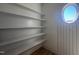 Pantry featuring built-in shelving and a round window for natural light at 142 Batten Hill Ln, Selma, NC 27576