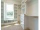Well-organized walk-in closet featuring custom shelving, drawers, and ample storage at 142 Batten Hill Ln, Selma, NC 27576