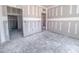 Spacious bedroom is under construction with drywall, unfinished floors, and multiple doorways to rooms at 1901 Old Bramble Ln # 3, Fuquay Varina, NC 27526