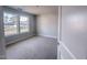 Bright bedroom with large windows offering neighborhood views and neutral gray walls at 1901 Old Bramble Ln # 3, Fuquay Varina, NC 27526