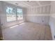Unfinished bedroom with windows overlooking the neighborhood, drywall walls and exposed flooring at 1901 Old Bramble Ln # 3, Fuquay Varina, NC 27526