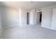 A spacious bedroom features neutral walls, trim, and multiple doorways leading to other rooms at 1901 Old Bramble Ln # 3, Fuquay Varina, NC 27526