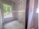 A bright bedroom space featuring a large window with a pleasant outdoor view at 1901 Old Bramble Ln # 3, Fuquay Varina, NC 27526