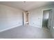 Spacious bedroom with large windows and an open doorway leading to another room at 1901 Old Bramble Ln # 3, Fuquay Varina, NC 27526