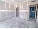 Bedroom under construction with drywall, unfinished floors, and multiple doorways at 1901 Old Bramble Ln # 3, Fuquay Varina, NC 27526