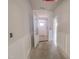 Neutral hallway with classic wainscoting, leading to the front door and other rooms at 1901 Old Bramble Ln # 3, Fuquay Varina, NC 27526