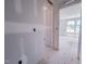 Hallway leading to a bright bedroom with a large window at 1901 Old Bramble Ln # 3, Fuquay Varina, NC 27526