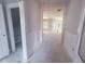 Well-lit hallway featuring wainscoting that leads to the living spaces, offering a clean and open design at 1901 Old Bramble Ln # 3, Fuquay Varina, NC 27526
