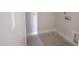 An unfinished laundry room with connections for a washer and dryer, freshly painted white at 1901 Old Bramble Ln # 3, Fuquay Varina, NC 27526