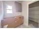 Functional laundry room with a window, cabinet and space for a washer and dryer, offering convenience at 1901 Old Bramble Ln # 3, Fuquay Varina, NC 27526