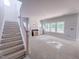 Spacious living room with fireplace, staircase, and ample natural light at 1901 Old Bramble Ln # 3, Fuquay Varina, NC 27526