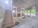 The living room is under construction featuring a staircase, fireplace, drywall, and large windows for natural light at 1901 Old Bramble Ln # 3, Fuquay Varina, NC 27526