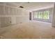 Bright living room with three large windows, drywall, and exposed flooring, awaiting your personal design touches at 1901 Old Bramble Ln # 3, Fuquay Varina, NC 27526