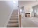 Living room with staircase, fireplace, and natural light from the backyard at 1901 Old Bramble Ln # 3, Fuquay Varina, NC 27526